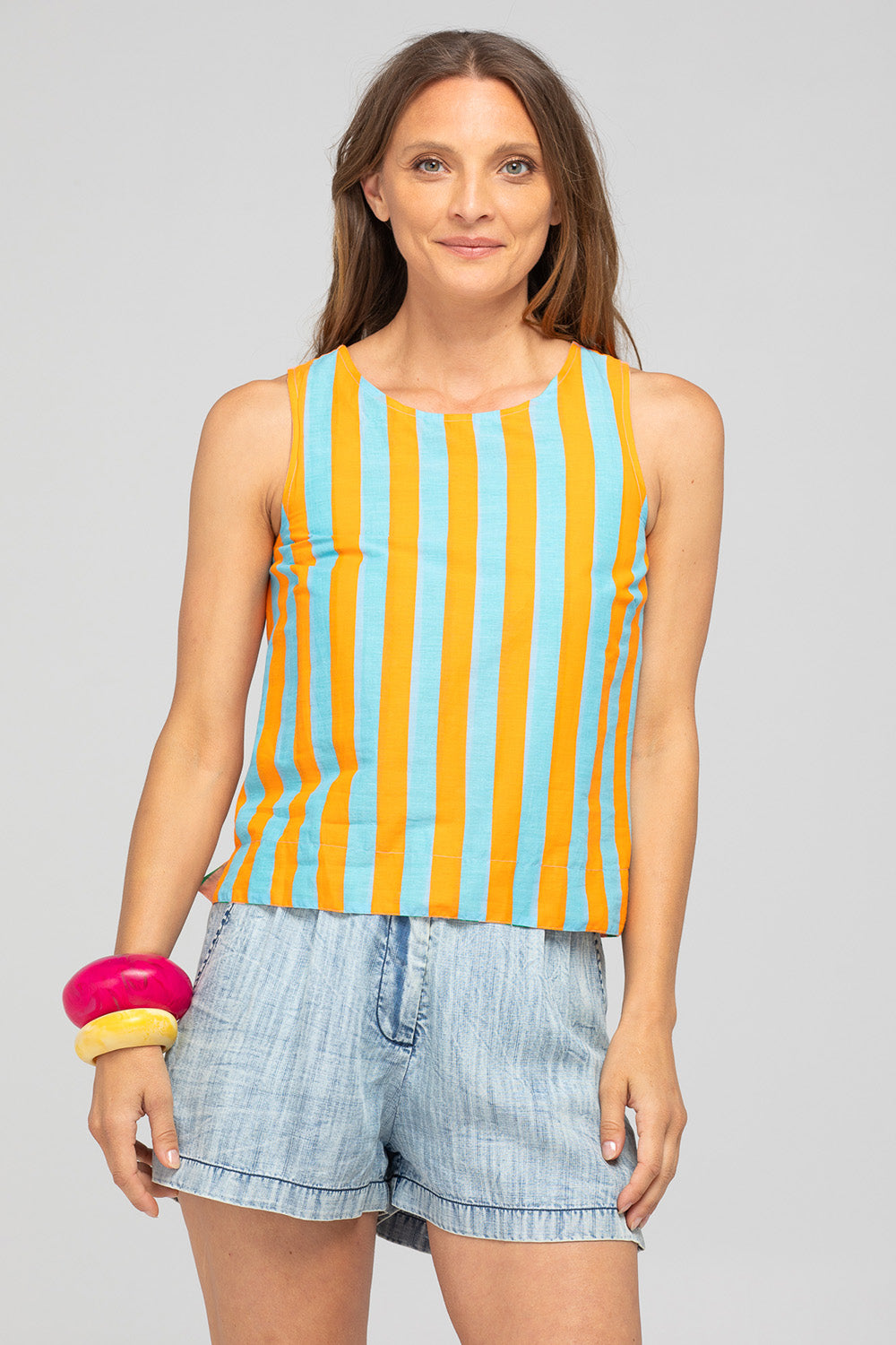 A model wearing the Hara Cotton Reversible Top in colour Capri (Green), from the front, cropped image