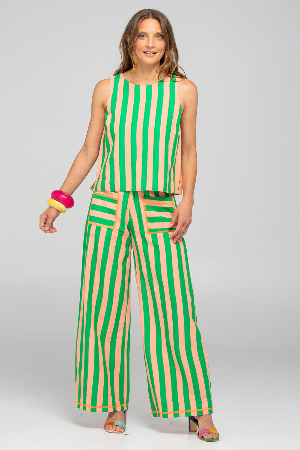 A model wearing the Hara Cotton Reversible Top in colour Capri (Green), from the front, showing the whole outfit