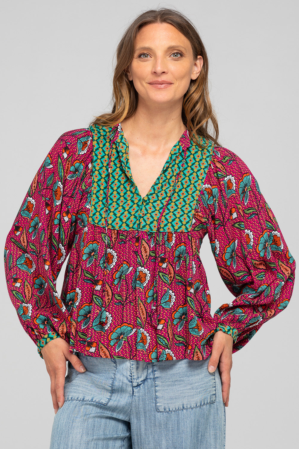 A model wearing the Noel Top in colour Toluca (Pink), from the front, cropped image