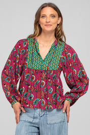 A model wearing the Noel Top in colour Toluca (Pink), from the front, cropped image