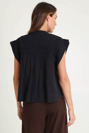 Model Madeline wearing size 10 of the Danika Cotton Top in colour Black (Black), from the back