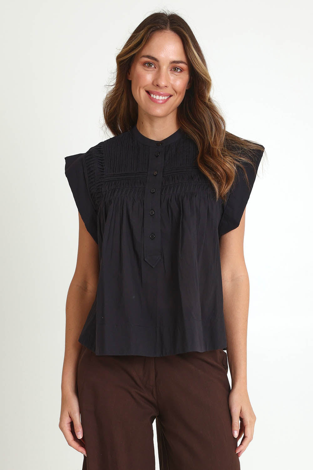 Model Madeline wearing size 10 of the Danika Cotton Top in colour Black (Black), from the front, cropped image