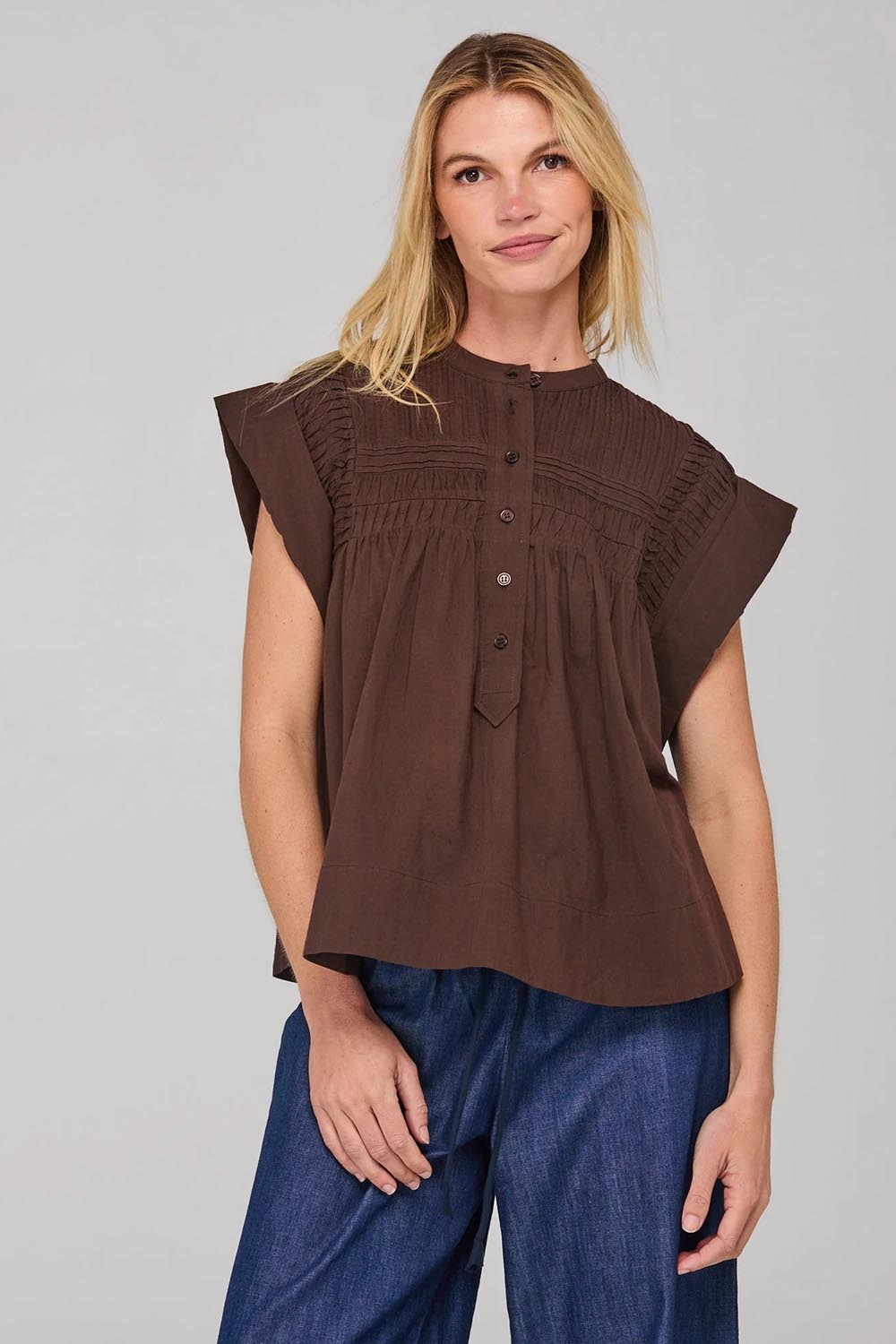 A model wearing the Danika Cotton Top in colour Coffee, from the front, cropped image