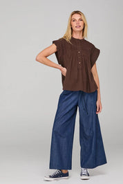 A model wearing the Danika Cotton Top in colour Coffee, from the front, showing the whole outfit
