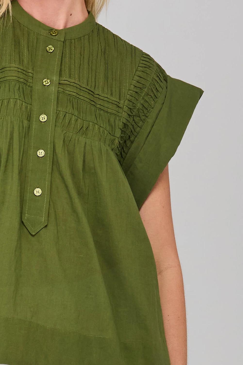 A model wearing the Danika Cotton Top in colour Khaki (Green), from the front, cropped image
