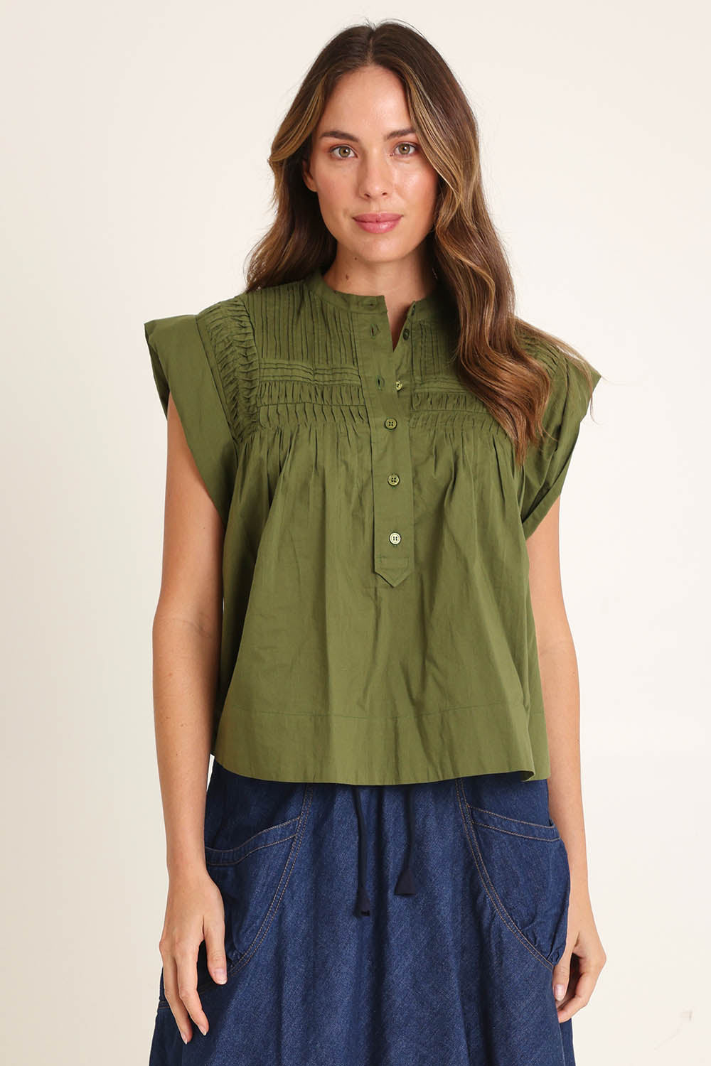 Model Madeline wearing size 10 of the Danika Cotton Top in colour Khaki (Green), from the front, cropped image