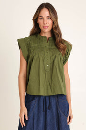Model Madeline wearing size 10 of the Danika Cotton Top in colour Khaki (Green), from the front, cropped image