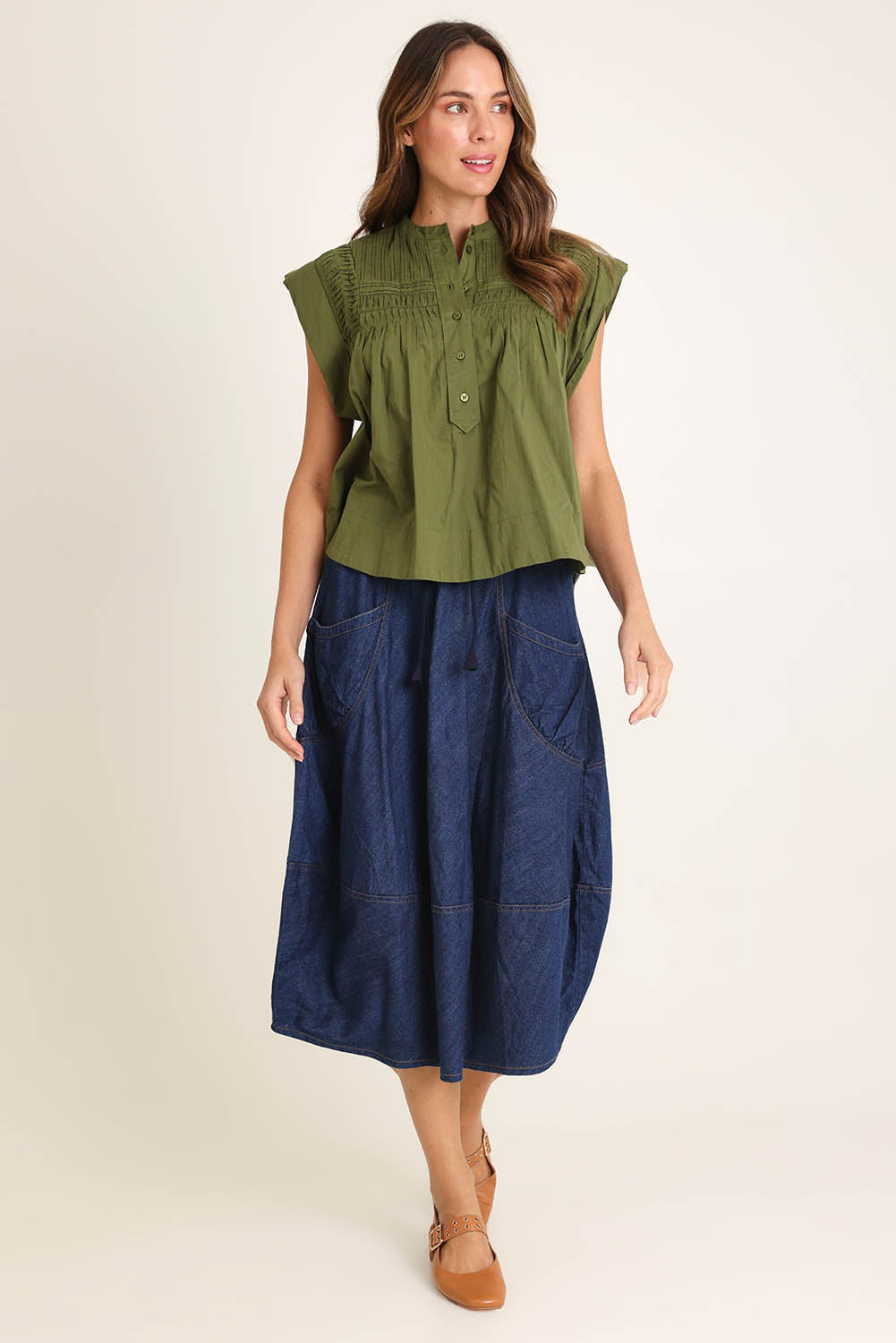 Model Madeline wearing size 10 of the Danika Cotton Top in colour Khaki (Green), from the front, showing the whole outfit