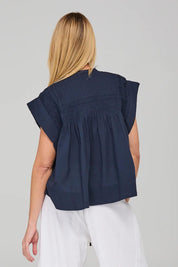 A model wearing the Danika Cotton Top in colour Navy (Blue), from the back