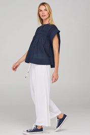 A model wearing the Danika Cotton Top in colour Navy (Blue), from the front, showing the whole outfit