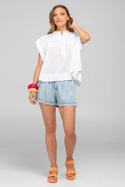 A model wearing the Danika Cotton Top in colour White (White), from the front, showing the whole outfit