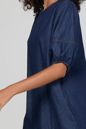 Model Genericm wearing size sample of the Ava Dress – Darkdenim in colour Darkdenim, from an angle