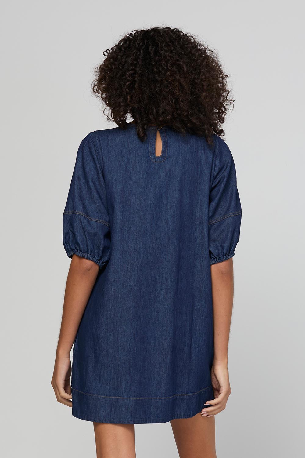 Model Genericm wearing size sample of the Ava Dress – Darkdenim in colour Darkdenim, from the back