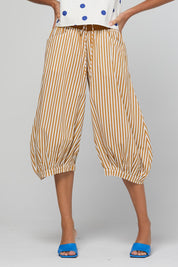 Model Genericm wearing size sample of the Guru Pant – Mustard in colour Mustard, in a cropped view