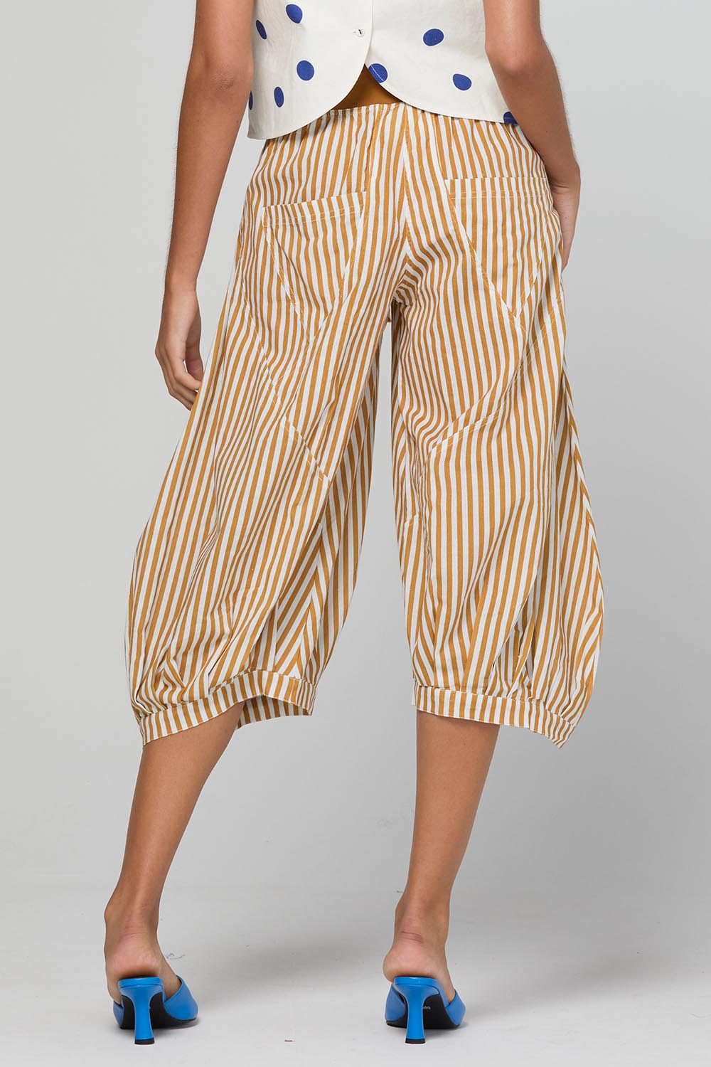 Model Genericm wearing size sample of the Guru Pant – Mustard in colour Mustard, from the front