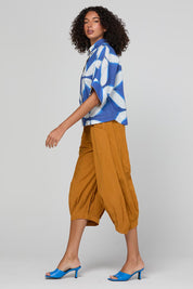 Model Genericm wearing size sample of the Guru Pant – Turmeric in colour Turmeric, from the front