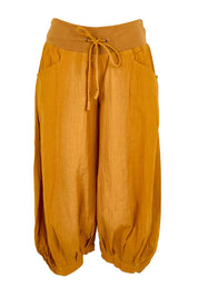 Product shot of the Guru Pant – Turmeric in colour Turmeric, from the front