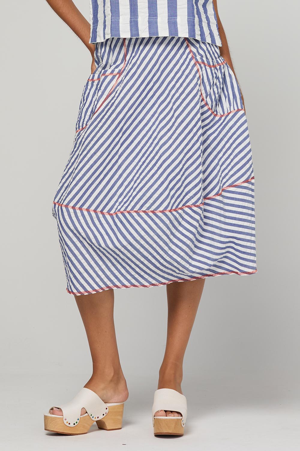 Model Genericm wearing size sample of the Guru Skirt – Ocean in colour Ocean, from an angle