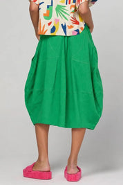 Model Genericm wearing size sample of the Guru Skirt – Apple in colour Apple, from the front