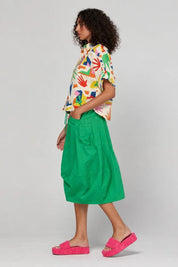 Model Genericm wearing size sample of the Guru Skirt – Apple in colour Apple, from the front