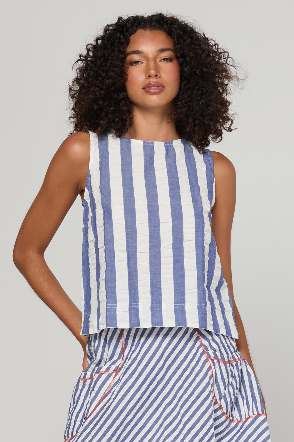 Model Genericm wearing size sample of the Hara Top – Ocean in colour Ocean, in a cropped view