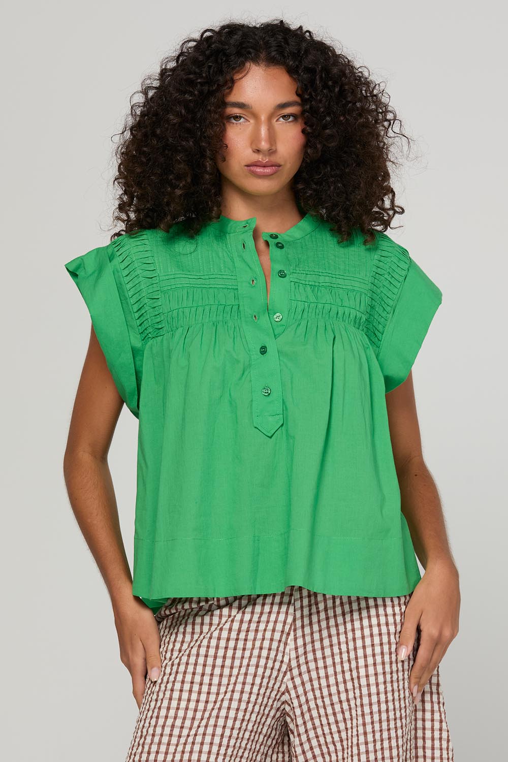 Model Genericm wearing size sample of the Danika Top – Apple in colour Apple, in a cropped view