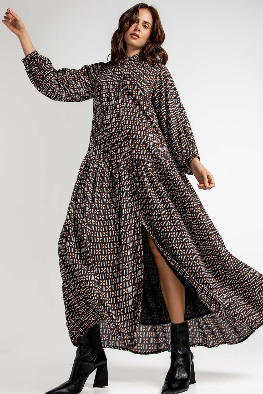 A model wearing the Magari Dress in colour Allora (Black), from the front, showing the whole outfit