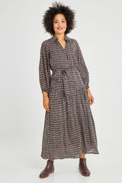Model Olivia wearing size 10 of the Magari Dress in colour Allora (Black), from the front, showing the whole outfit