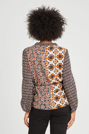 Model Olivia wearing size 10 of the Anne Top in colour Siennaspli (Black), from the back