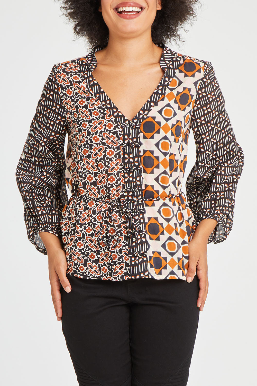 Model Olivia wearing size 10 of the Anne Top in colour Siennaspli (Black), from the front, cropped image