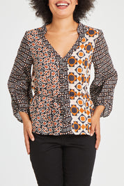 Model Olivia wearing size 10 of the Anne Top in colour Siennaspli (Black), from the front, cropped image
