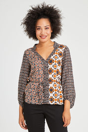 Model Olivia wearing size 10 of the Anne Top in colour Siennaspli (Black), from the front, cropped image