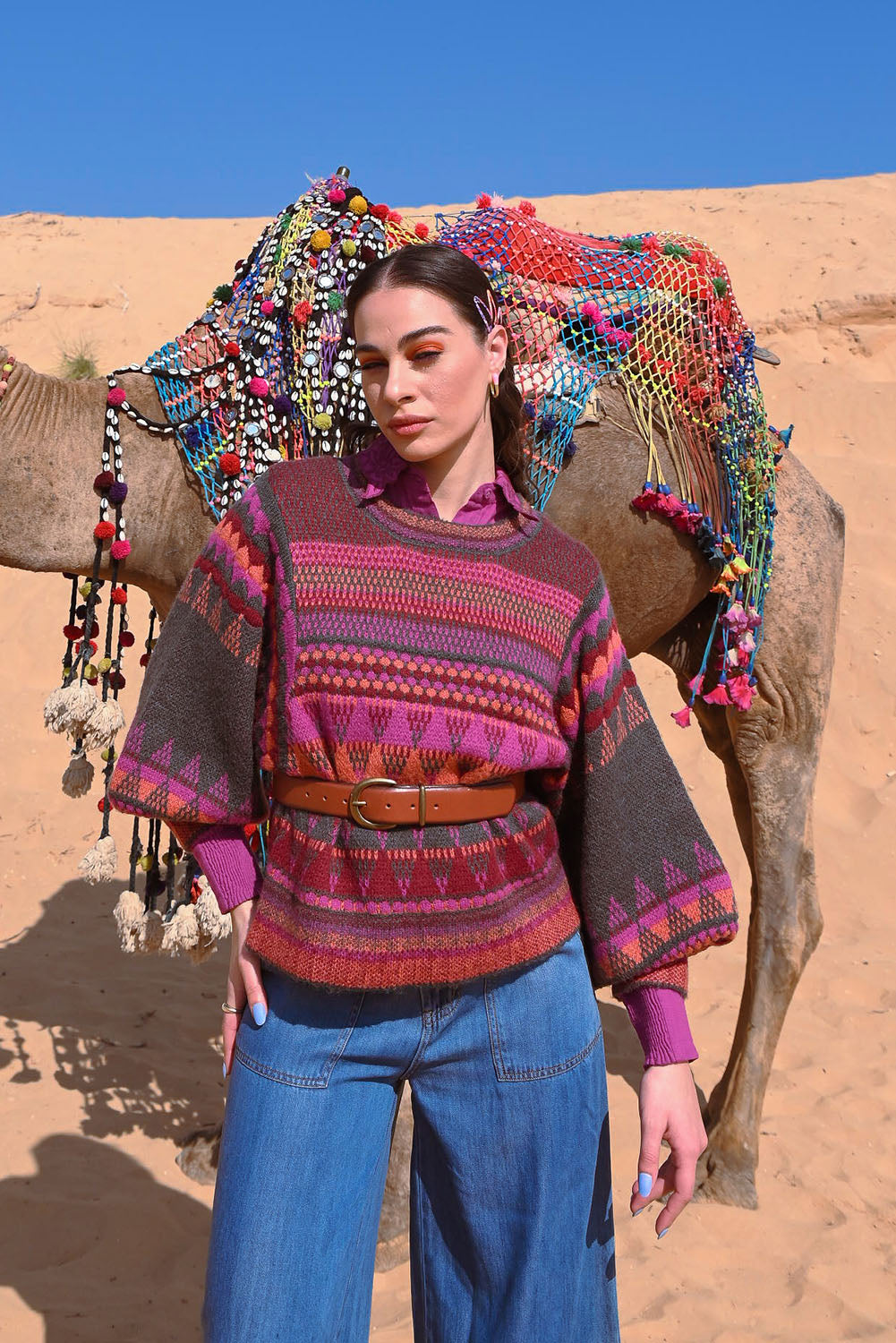 A model wearing the Sofia Jumper in colour Berry (Red), from the front, showing the whole outfit