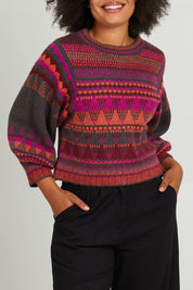 Model Olivia wearing size S of the Sofia Jumper in colour Berry (Red), from the front, cropped image