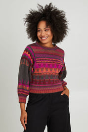 Model Olivia wearing size S of the Sofia Jumper in colour Berry (Red), from the front, cropped image