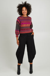 Model Olivia wearing size S of the Sofia Jumper in colour Berry (Red), from the front, showing the whole outfit