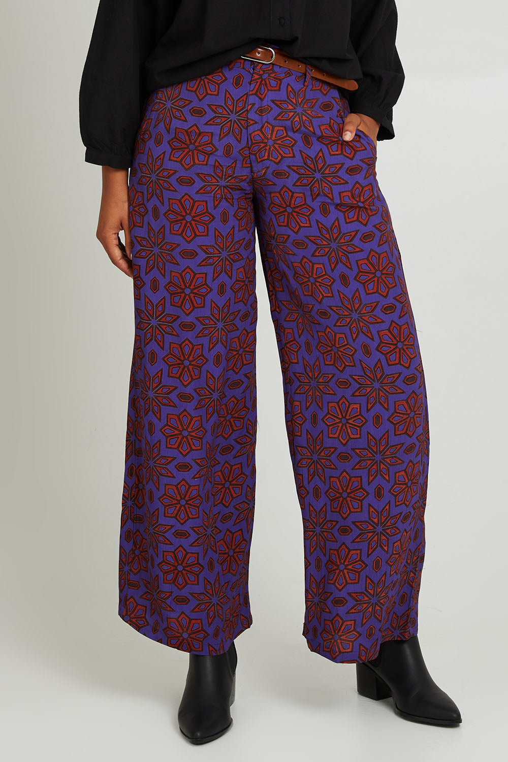 Model Olivia wearing size 10 of the Sara Pant in colour Rio (Purple), from the front, cropped image