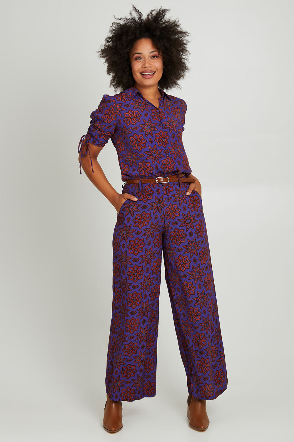 Model Olivia wearing size 10 of the Sara Pant in colour Rio (Purple), from the front, showing the whole outfit
