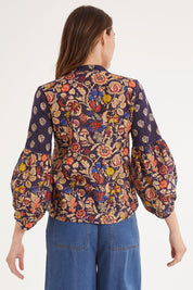Model Madeline wearing size 10 of the Mittee Top in colour Cella (Blue), from the back