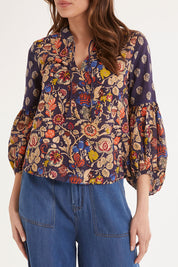 Model Madeline wearing size 10 of the Mittee Top in colour Cella (Blue), from the front, cropped image