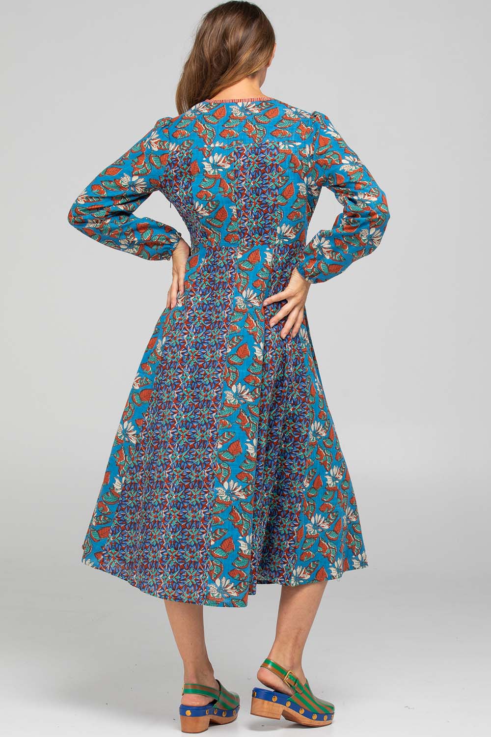 A model wearing the Lettie Cotton Dress in colour Lettie (Blue), from the back