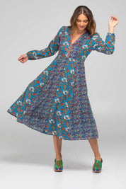 A model wearing the Lettie Cotton Dress in colour Lettie (Blue), from the front, showing the whole outfit
