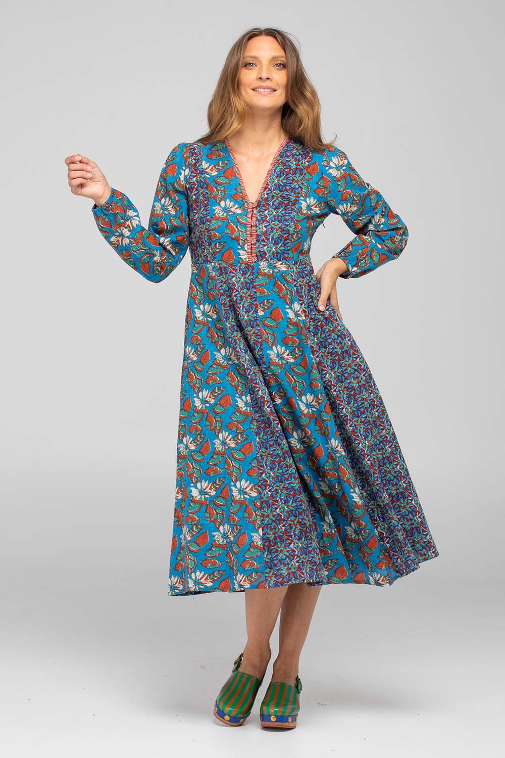 A model wearing the Lettie Cotton Dress in colour Lettie (Blue), from the front, showing the whole outfit