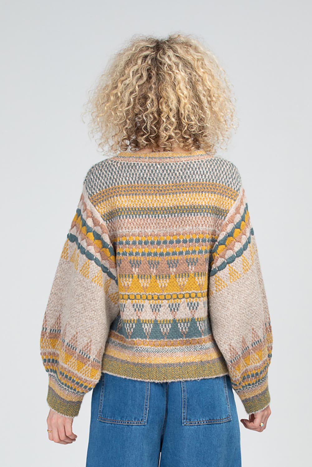 A model wearing the Sofia Wool Blend Jumper in colour Oatmeal, from the back