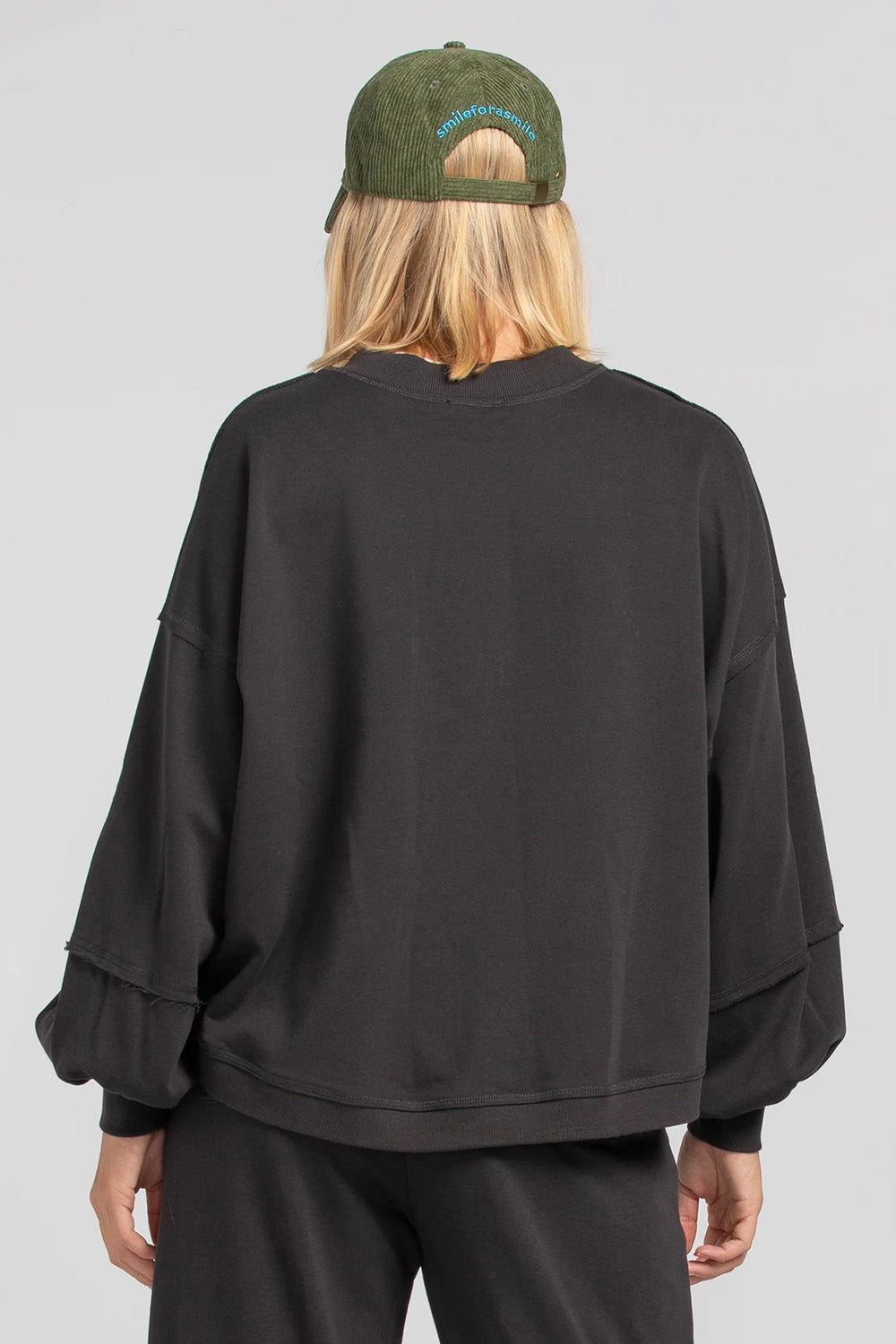 A model wearing the Guru Cotton Blend Sweater in colour Black (Black), from the back