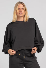 A model wearing the Guru Cotton Blend Sweater in colour Black (Black), from the front, cropped image
