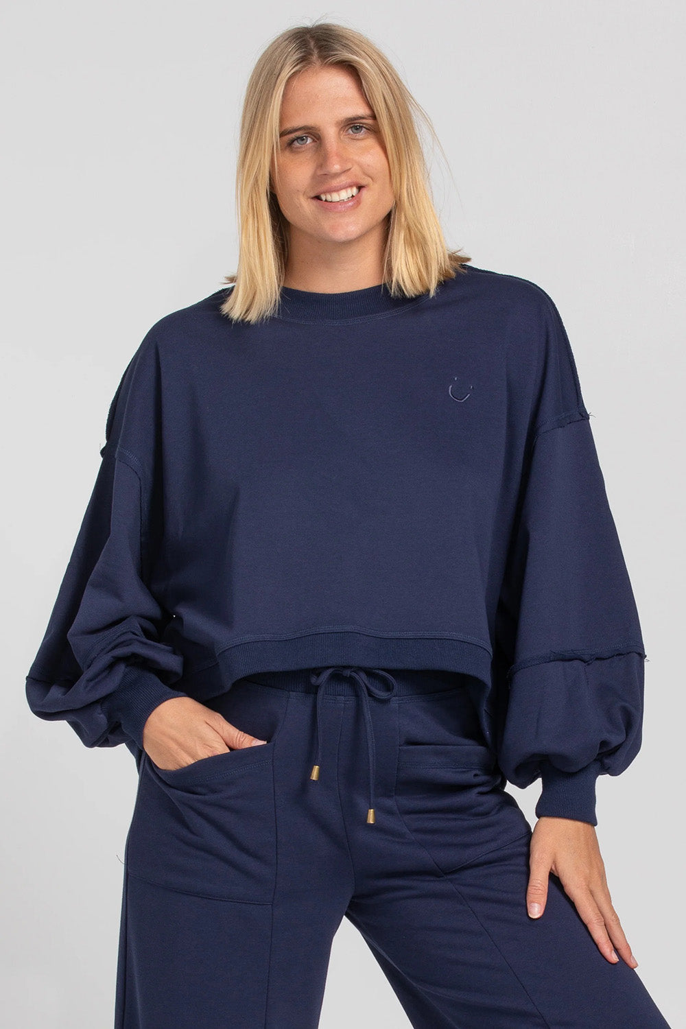 A model wearing the Guru Cotton Blend Sweater in colour Navy (Blue), from the front, cropped image