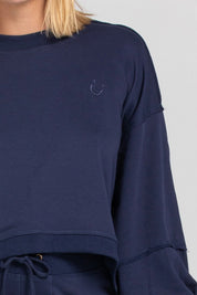 A model wearing the Guru Cotton Blend Sweater in colour Navy (Blue), from the front, cropped image