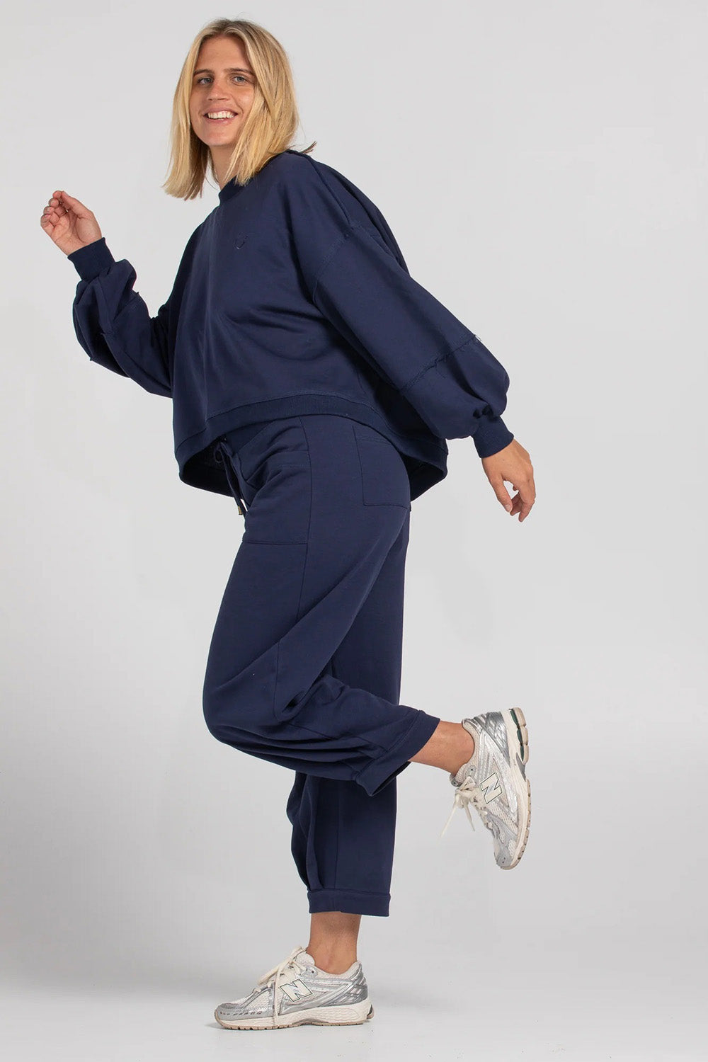 A model wearing the Guru Cotton Blend Sweater in colour Navy (Blue), from the front, showing the whole outfit