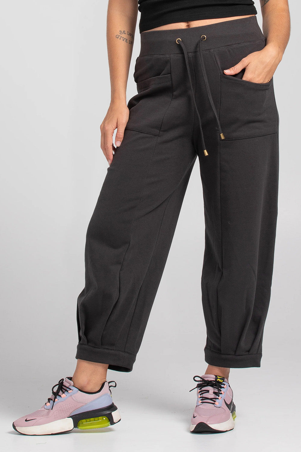 A model wearing the Guru Cotton Blend Track in colour Black (Black), from the front, cropped image